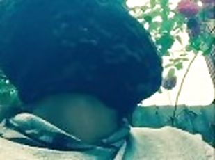 Masked ebony bbw smoking outside in garden and rubbing pussy