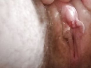 Close-up of pussy and large clit while pissing