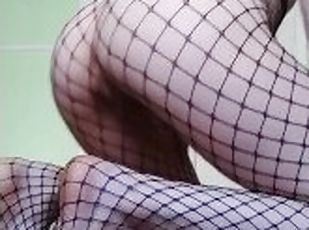 Petite girl in fishnets show her holes