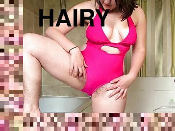 Hairy Beryl Aspen in a pink swimsuit takes a bath