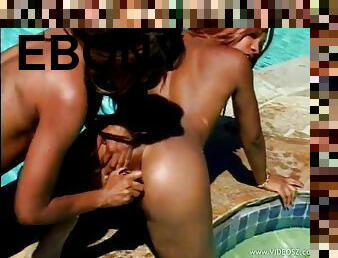 Ebony babes have a lesbian scene on the pool