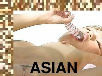 Sexy asian masturbating with glass toy