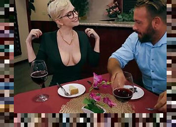 Busty blonde teases lad with her boobs at dinner table
