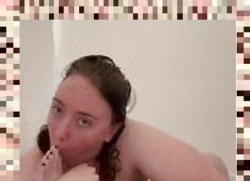 Naughty girl sucks her toes and masturbates in the shower