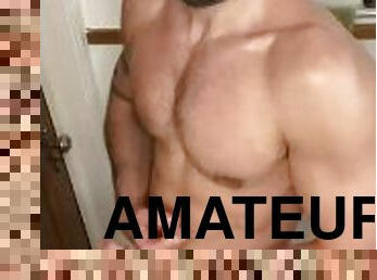 Bearded jock flexes in bathroom