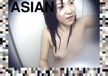 Two Asian Women in a Cramped Bathroom