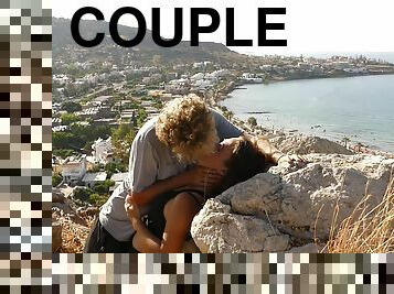 Beautiful Teen Couple In Love Passionately Kissing Above The Sea On Crete Island