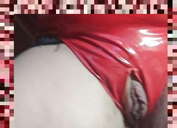 Pissing in red latex close up