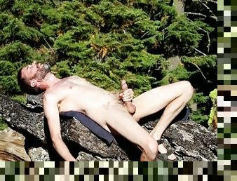 Daddy with a big cock enjoys showing off outside on a sunny day in a public forest