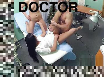 Nurse tugs doctor with patient in threesome