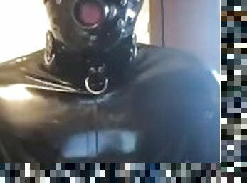 Full rubber gimp shows off suit and jerks off