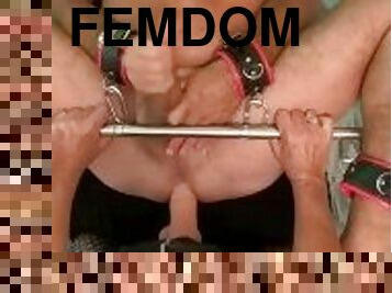 Femdom pegging sub locked in spreader bar till he cums - top view