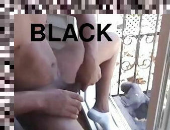 Jerking black dick in front of window