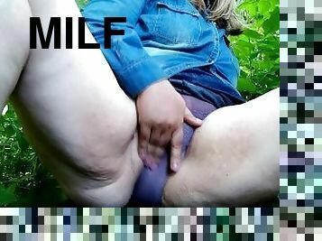 Playful MILF masturbates through panties in outdoor with her legs spread wide