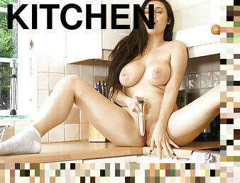 Brunette Gabriella Knight with big tits eagerly fucks herself in the kitchen