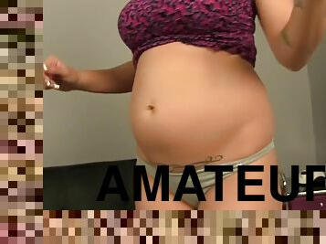 Pregnant lady posing solo and showing off her big sexy belly