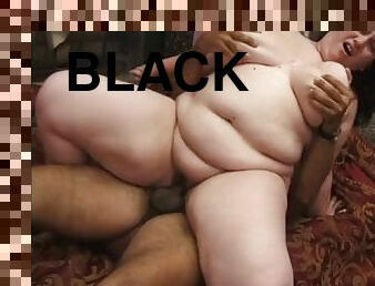 BBW brunette gets pounded by a white cock while sucking on a black one
