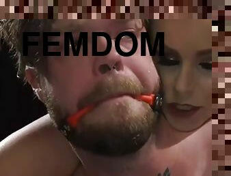 Femdom scene with a busty mistress pegging a guy