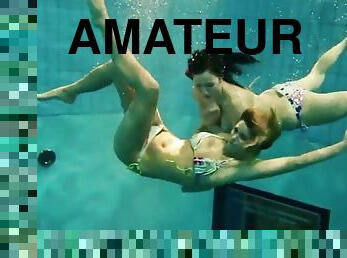 Two sexy amateurs showing off their body under water