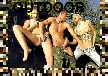 Two girls and one guy fuck outdoors in the field
