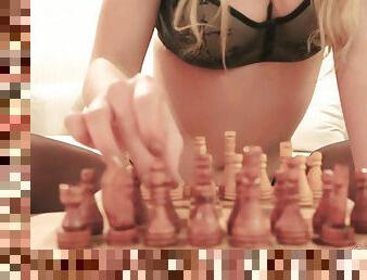 Cute blonde masturbates next to her chess on bed