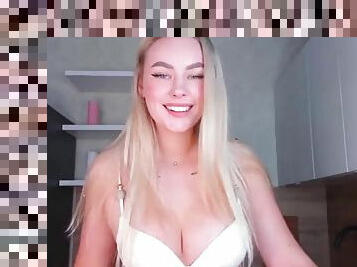 Sexy blonde babe with big boobs strips her bra