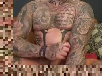 Tattoed muscle hunk stroking his monster cock with both hands