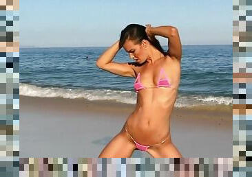 Fit babe in a micro bikini at the beach