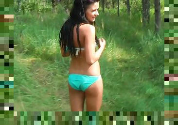 Tanned brunette is sucking black dick in the forest