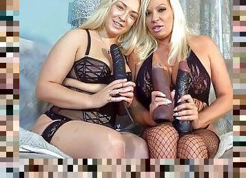 Two blondes in black stockings and heels with big toys