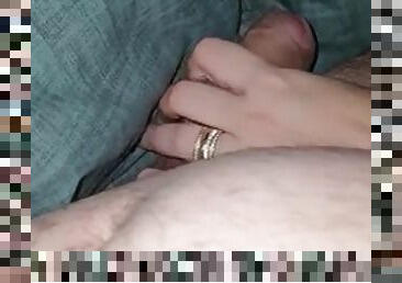 Wife helps her husband with an erection by jerking off under the blanket